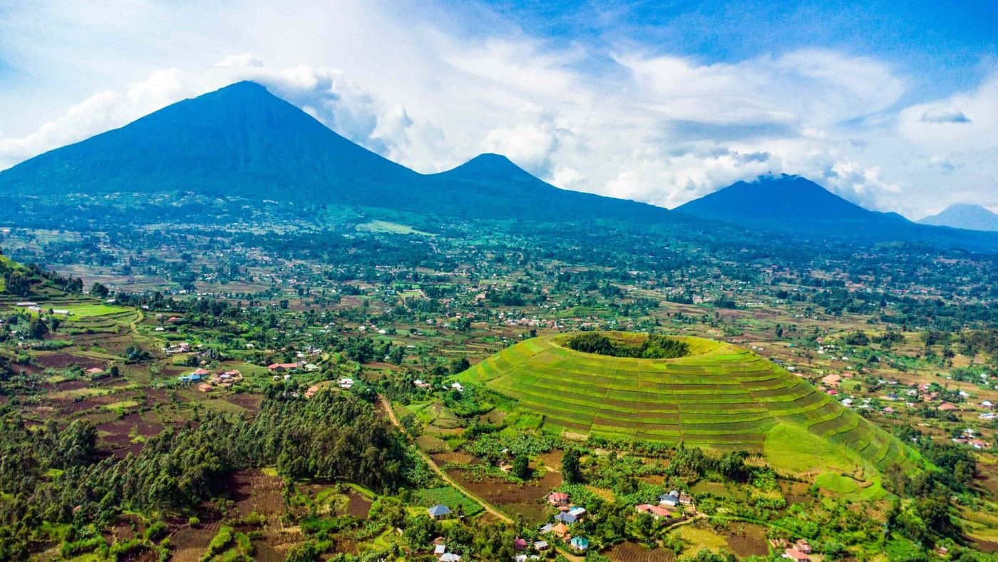 The Virunga volcanoes rising behind terraced farmland near Kisoro